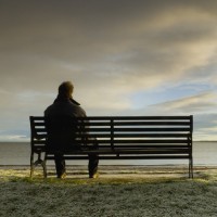thoughtful man on park bench